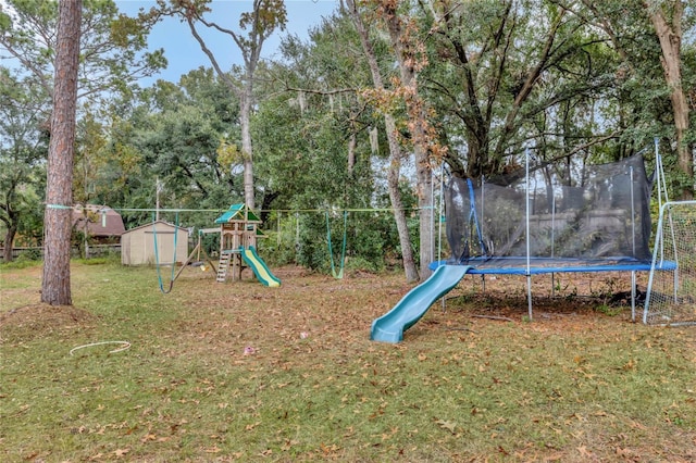 view of playground featuring a trampoline and a yard