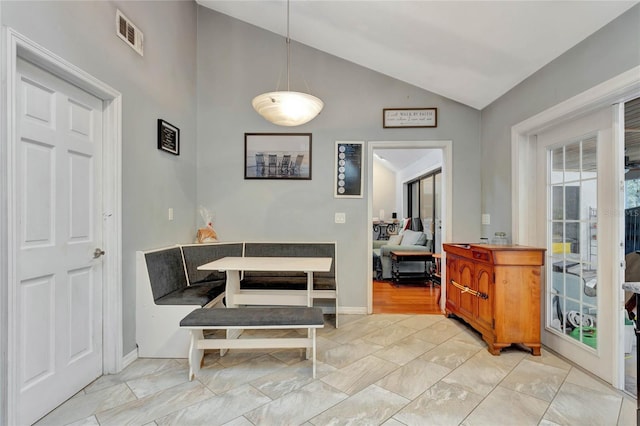 dining room featuring vaulted ceiling