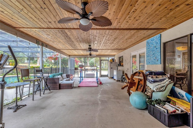 sunroom with ceiling fan and wood ceiling