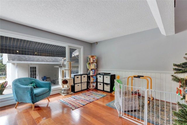 sitting room featuring wood-type flooring and a textured ceiling