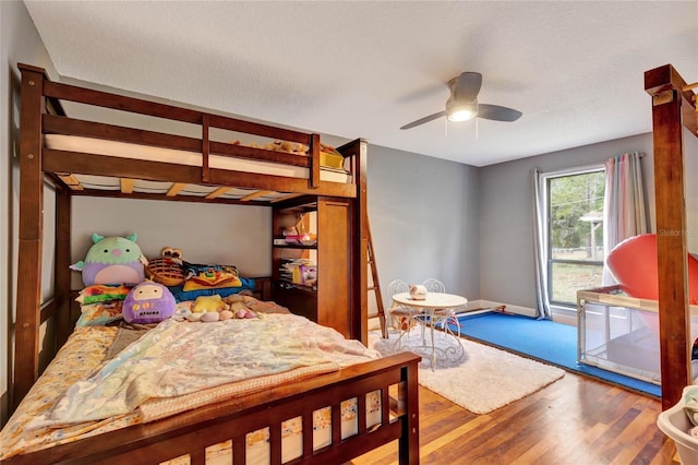 bedroom with hardwood / wood-style flooring and ceiling fan