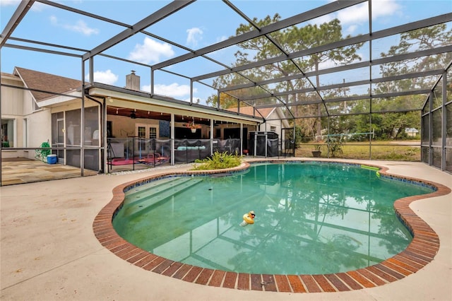 view of swimming pool with a patio and glass enclosure