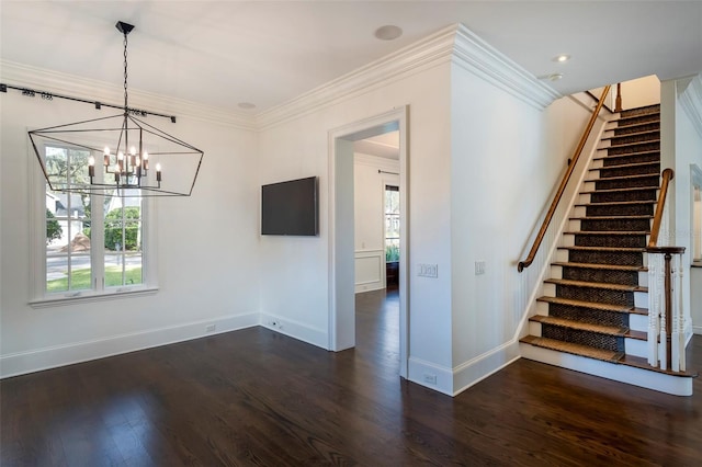 unfurnished dining area with dark hardwood / wood-style flooring, crown molding, a chandelier, and a healthy amount of sunlight