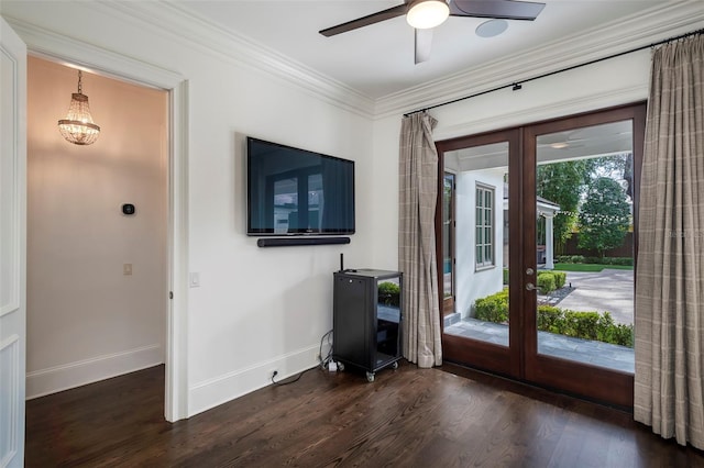 doorway featuring crown molding, dark wood-type flooring, ceiling fan, and french doors