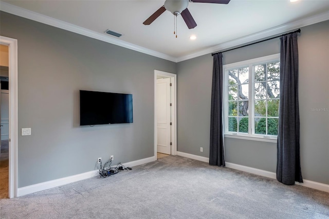 unfurnished living room with ornamental molding, light colored carpet, and ceiling fan