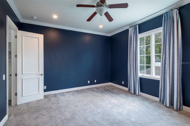 carpeted spare room featuring ornamental molding and ceiling fan