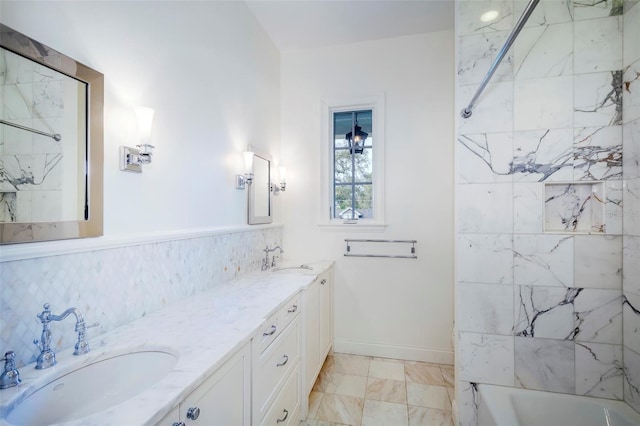 bathroom featuring tiled shower / bath and vanity