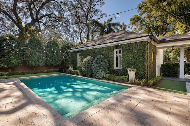 view of swimming pool with an outbuilding and a patio area