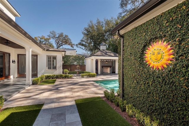 view of swimming pool featuring an outbuilding and a patio