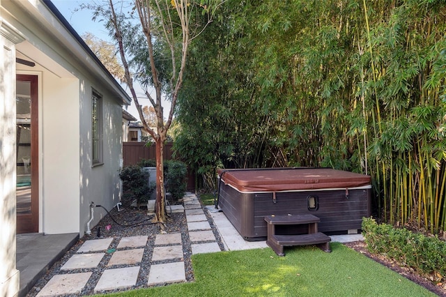 view of yard featuring a hot tub and a patio