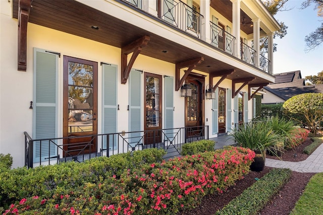 view of exterior entry featuring a balcony