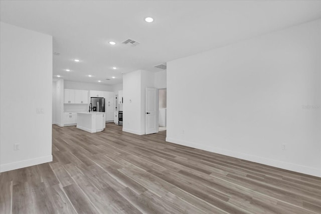 unfurnished living room featuring light hardwood / wood-style floors