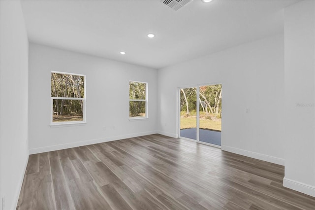 empty room with hardwood / wood-style flooring