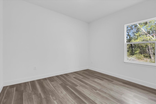 spare room with hardwood / wood-style floors