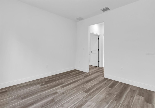 unfurnished room with wood-type flooring