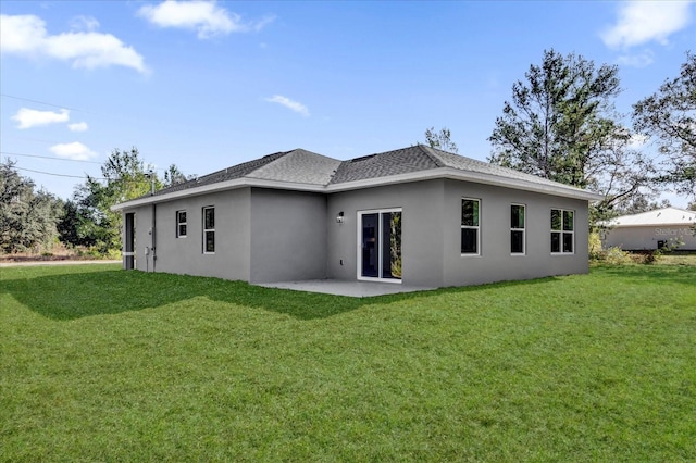 back of property featuring a lawn and a patio area