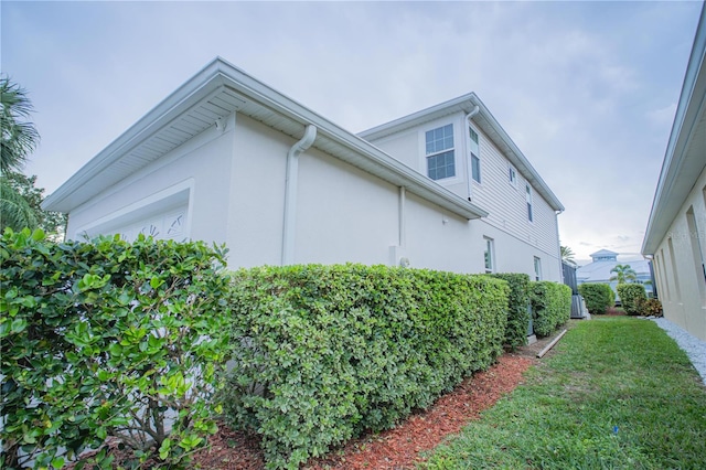 view of side of home with a lawn