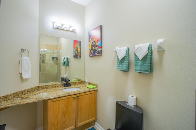 bathroom with vanity and a shower with door