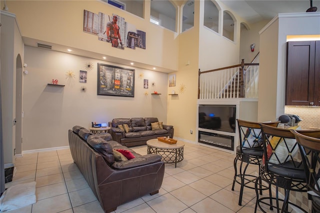 tiled living room with a towering ceiling