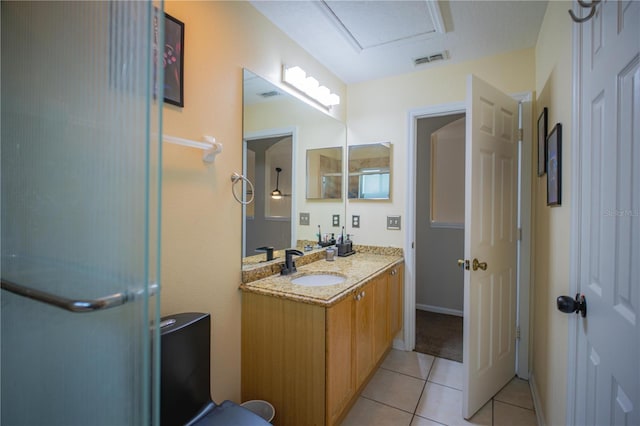 bathroom featuring tile patterned flooring, vanity, and a shower with shower door