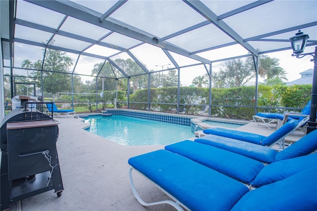 view of swimming pool featuring a patio and glass enclosure