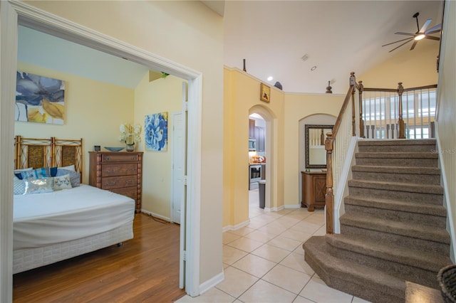 interior space featuring ceiling fan, wood-type flooring, and vaulted ceiling