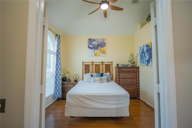 bedroom featuring vaulted ceiling, ceiling fan, and dark hardwood / wood-style floors