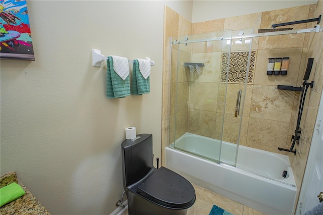 bathroom featuring toilet and combined bath / shower with glass door