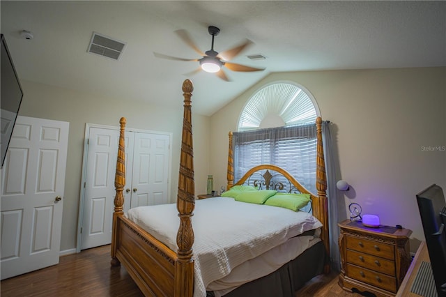 bedroom with ceiling fan, dark hardwood / wood-style floors, and vaulted ceiling