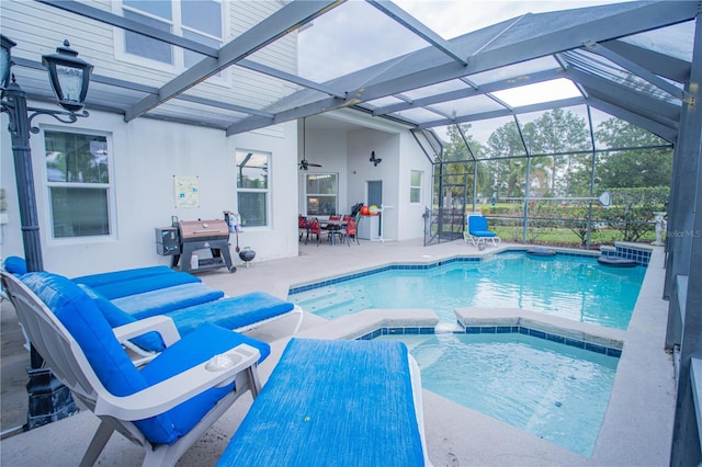 view of swimming pool with a lanai, an in ground hot tub, and a patio