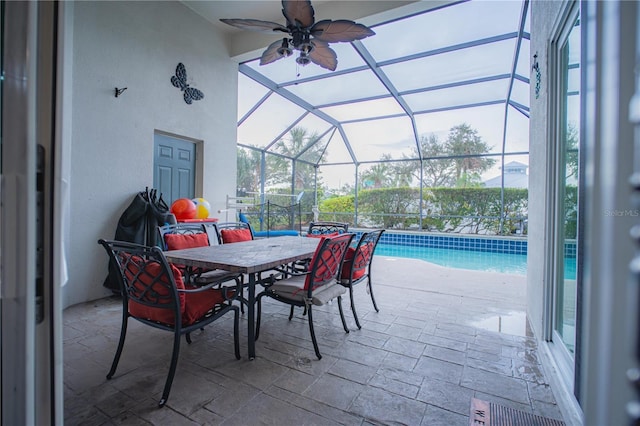 view of patio with ceiling fan and a lanai