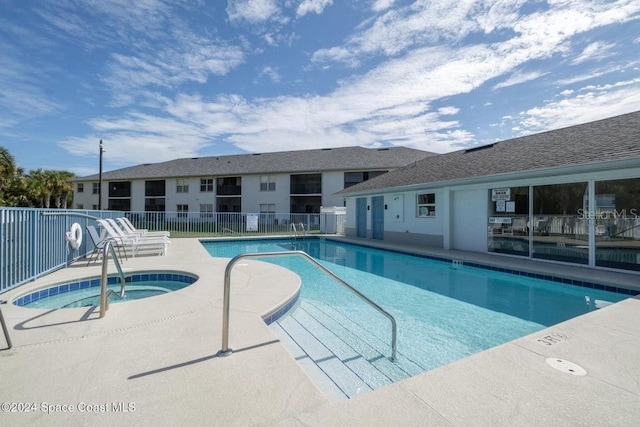 view of swimming pool featuring a community hot tub