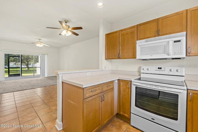 kitchen with kitchen peninsula, light tile patterned floors, white appliances, and ceiling fan