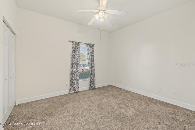 carpeted empty room with ceiling fan