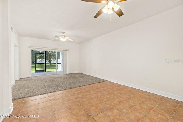 carpeted spare room with ceiling fan