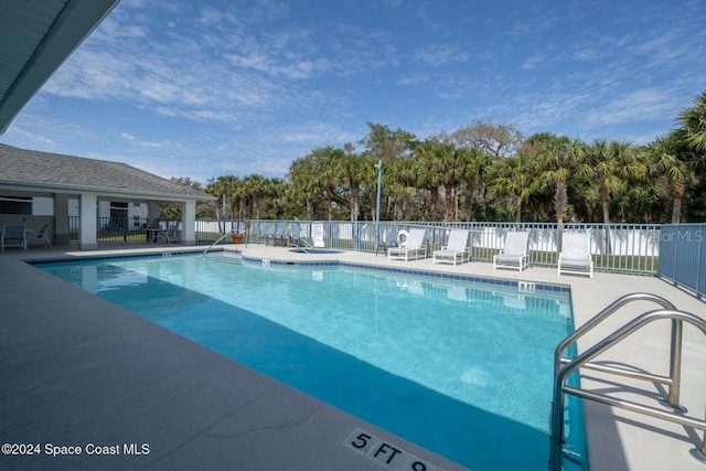 view of swimming pool with a patio area