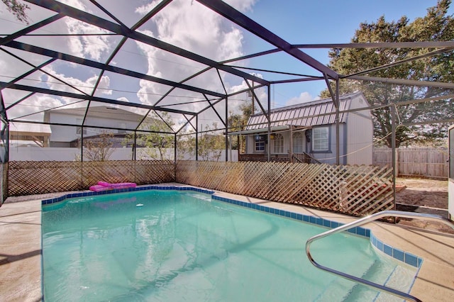 view of pool featuring glass enclosure