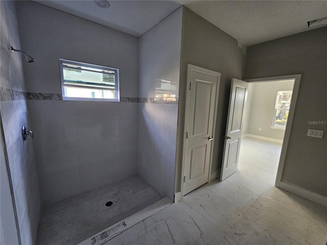 bathroom with a tile shower