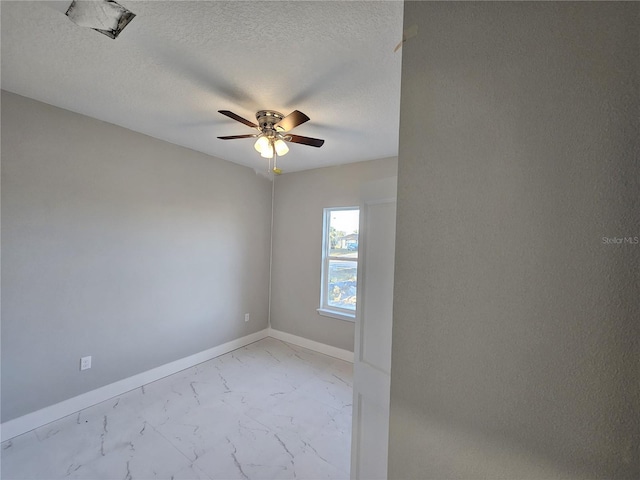 unfurnished room featuring a textured ceiling and ceiling fan