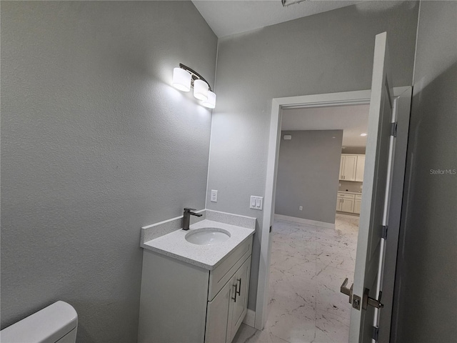 bathroom featuring toilet and vanity