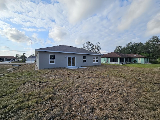 back of property featuring a yard