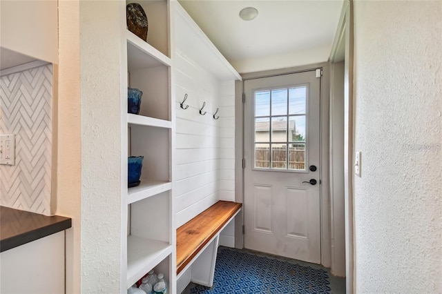 mudroom with a textured wall