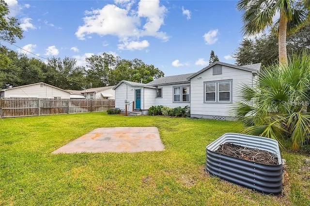 back of house with a lawn, a patio area, and fence