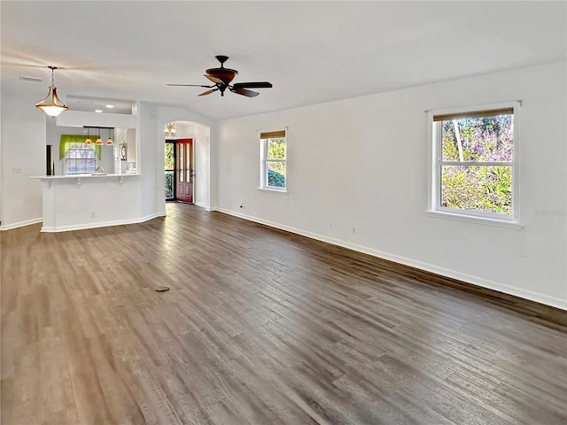 unfurnished living room featuring ceiling fan and wood-type flooring