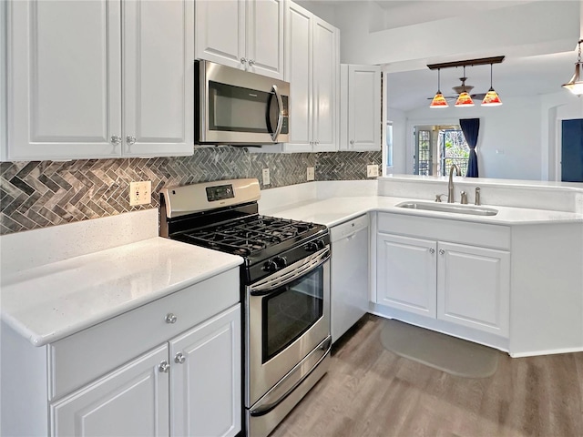 kitchen with white cabinetry, sink, and appliances with stainless steel finishes