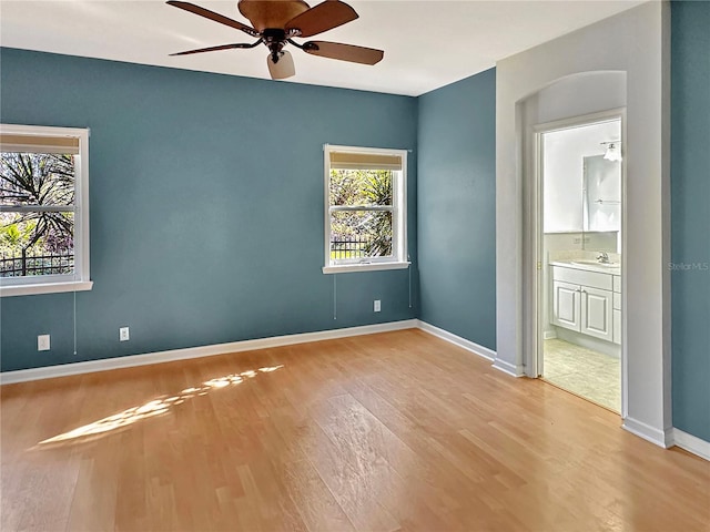 empty room featuring ceiling fan, light hardwood / wood-style floors, and sink