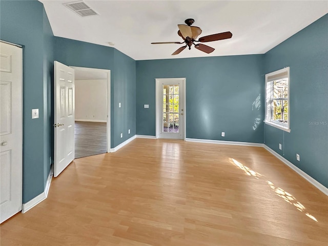 empty room with ceiling fan and light wood-type flooring