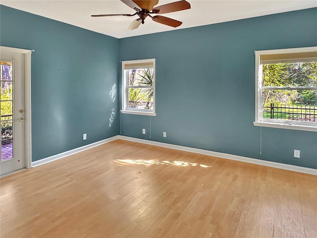 unfurnished room featuring light hardwood / wood-style floors, a wealth of natural light, and ceiling fan