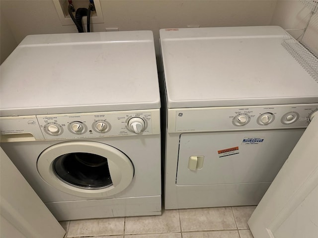 washroom with washer and dryer and light tile patterned flooring