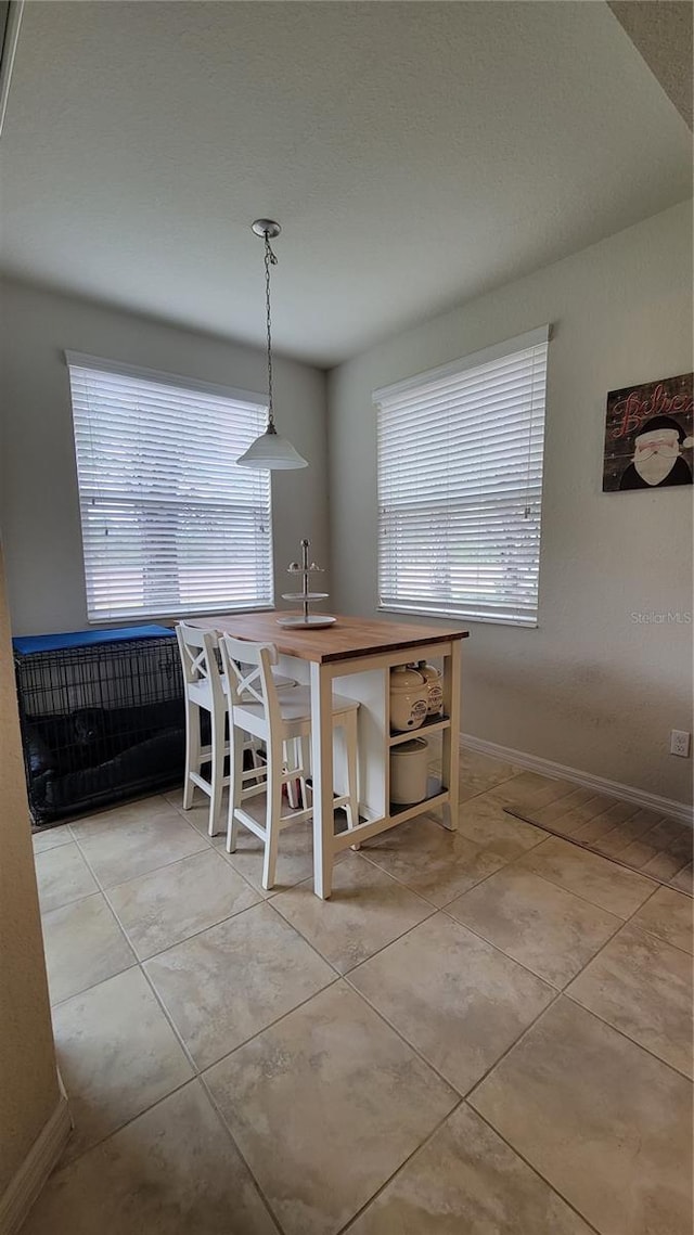 dining room with sink and light tile patterned flooring